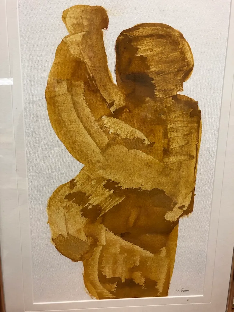 A framed painting in ochre wash: two figures pressed together, one head resting against the other.